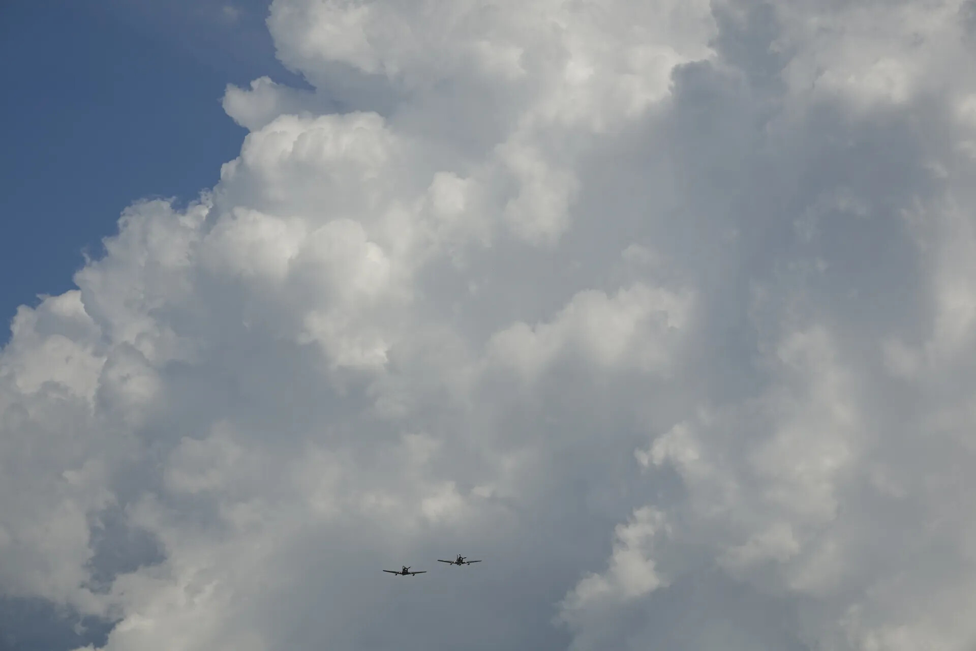 Two Aircraft in Formation Against Cumulus Cloud, May 2019 Airshow Event
