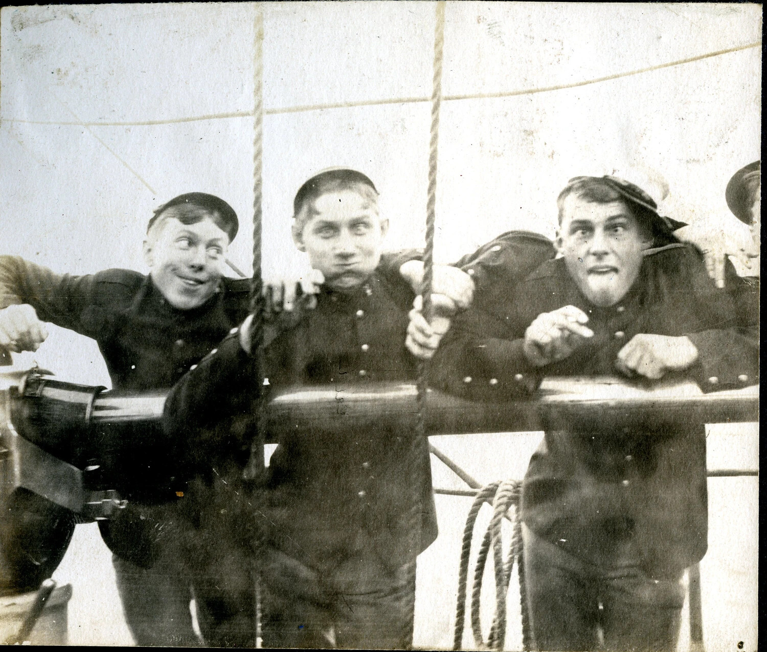 Three Sailors Clowning for the Camera Beside a Deck Gun, USS Columbia Album, c. 1900s