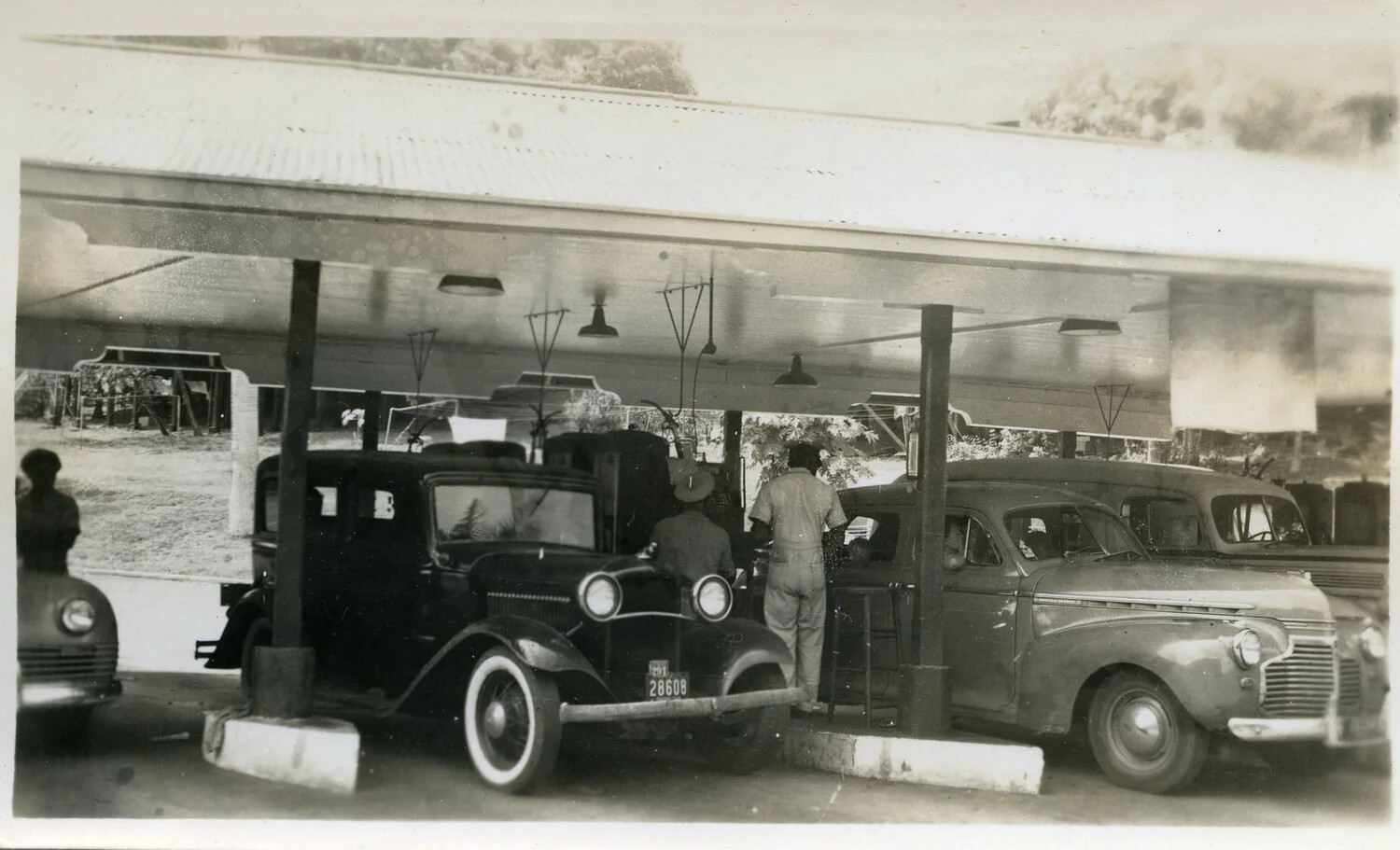 Vehicle Servicing Under Open-Air Carport, Occupied Japan, Postwar Period