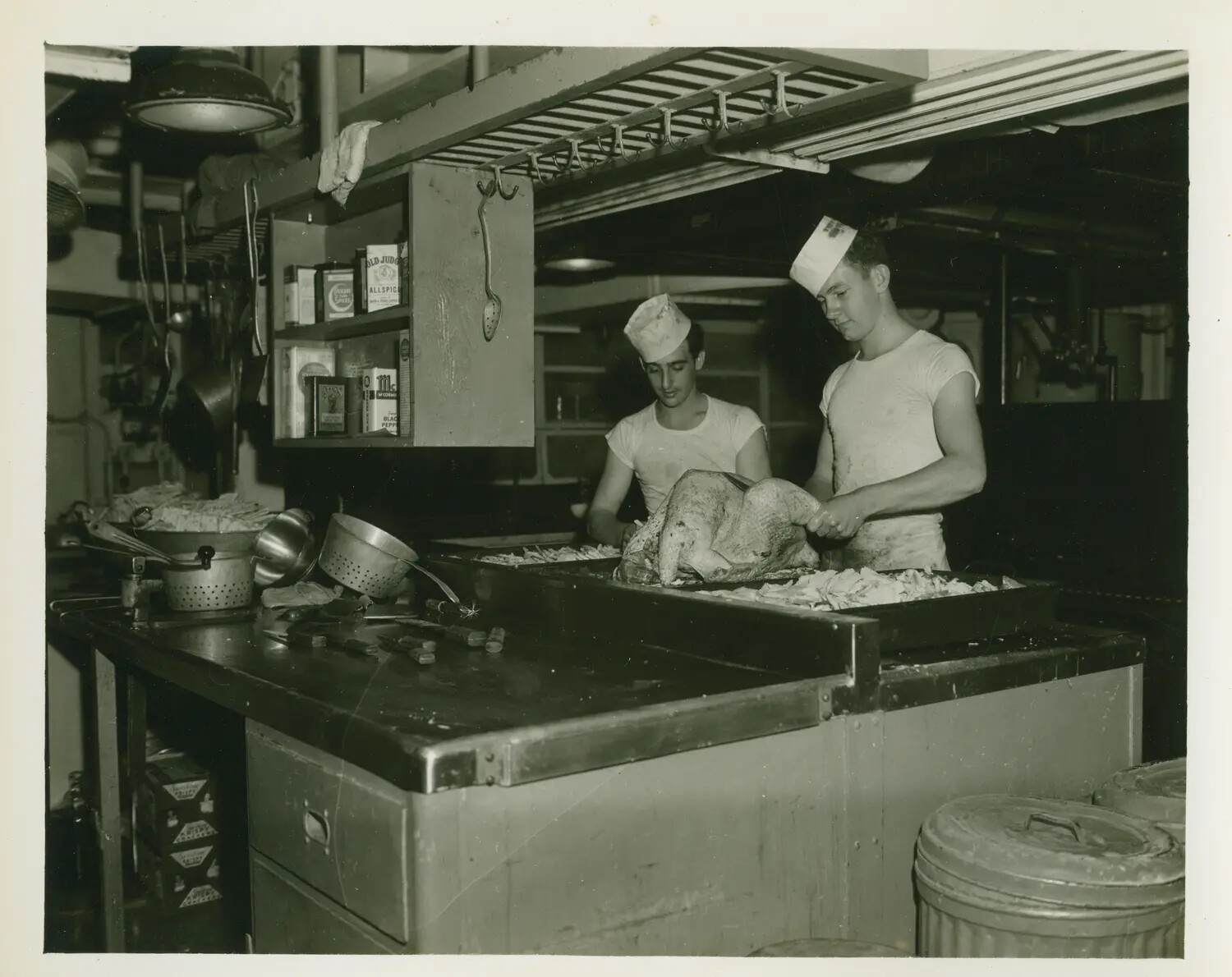 Ship's Cooks Preparing Turkeys in the Galley, USS Petrof Bay