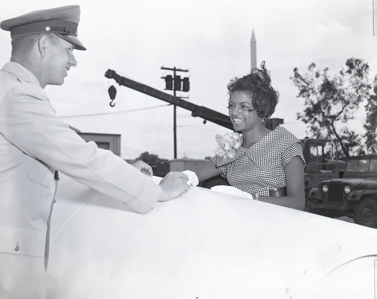 Officer Presenting Token to Seated Woman Beside Rocket Motor Casing, Aerojet Open House, Early 1960s
