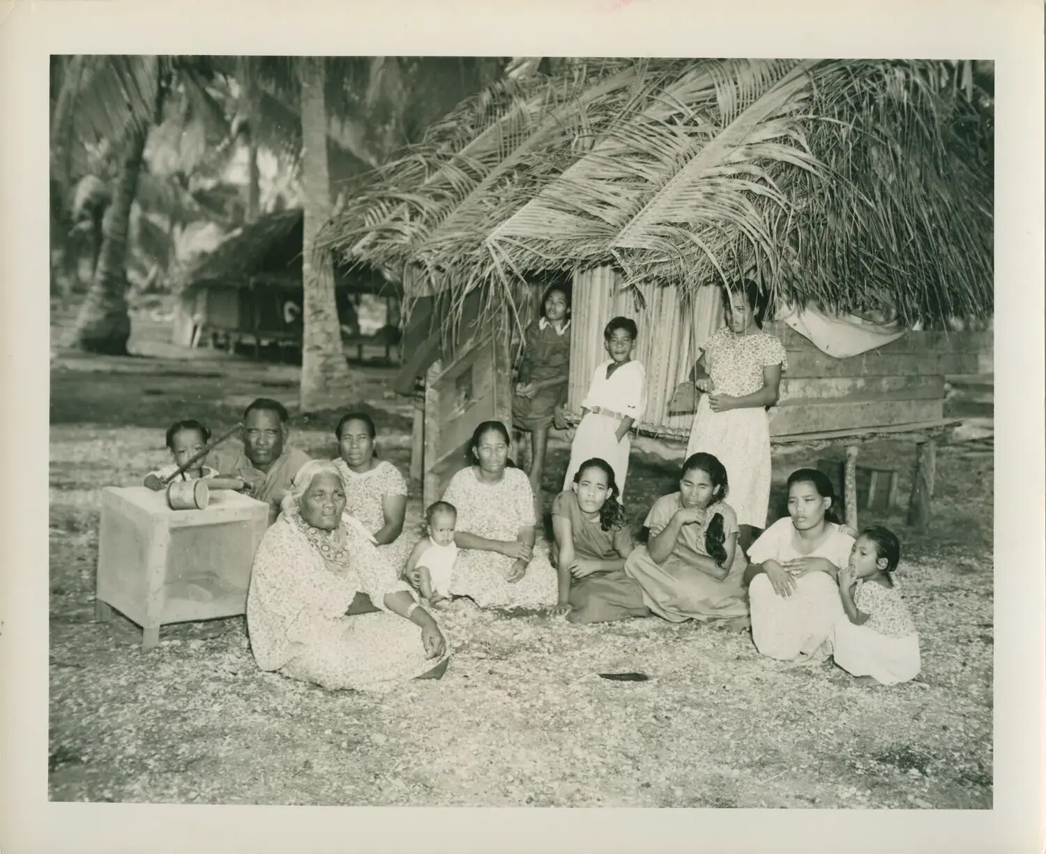 Pacific Islander Family Group Portrait Outside Thatched Dwelling, WWII Pacific Theater