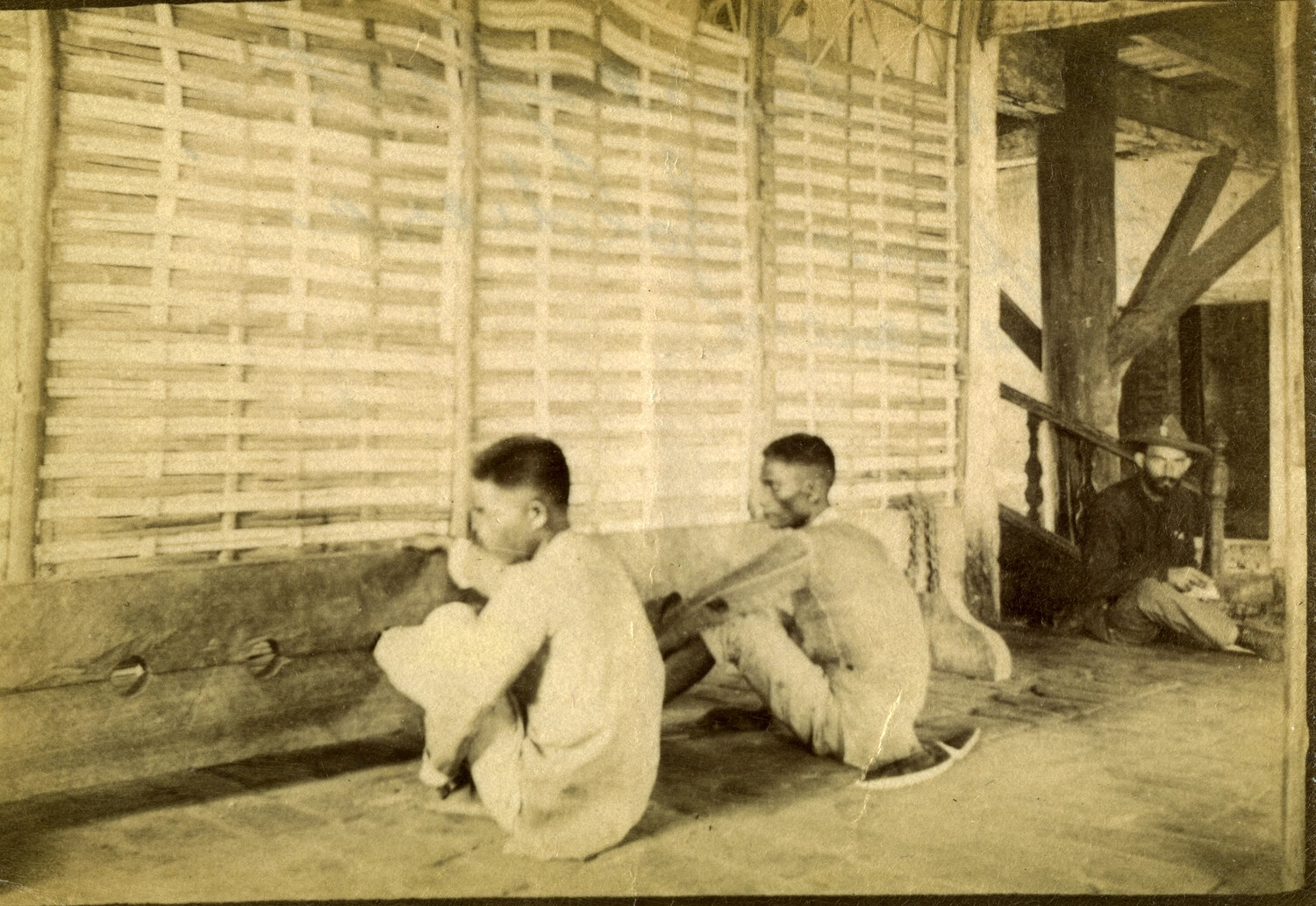 Interior Scene with Filipino Men and American Serviceman, Philippines, Early 1900s