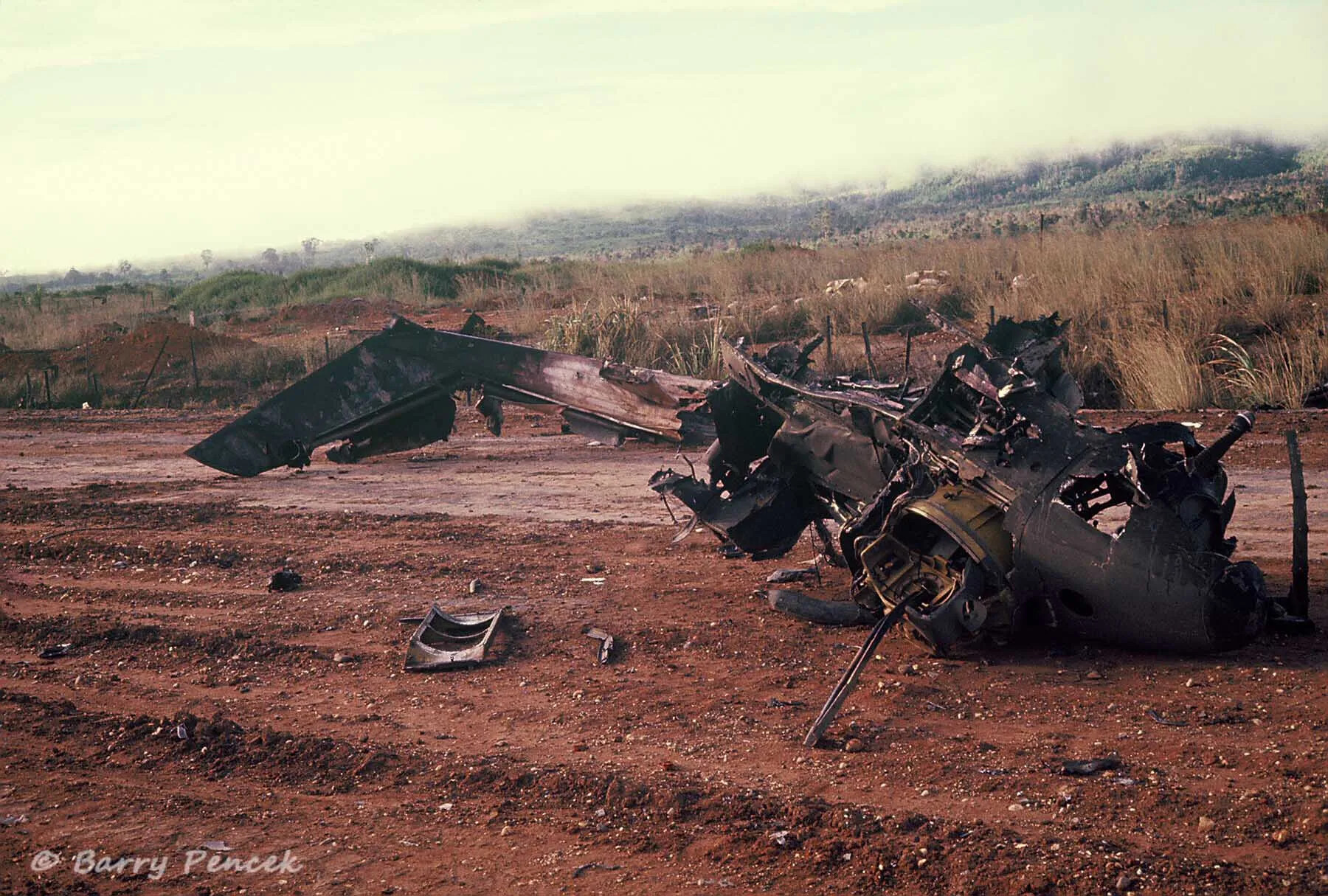 Burned Helicopter Wreckage in Laotian Highland Terrain