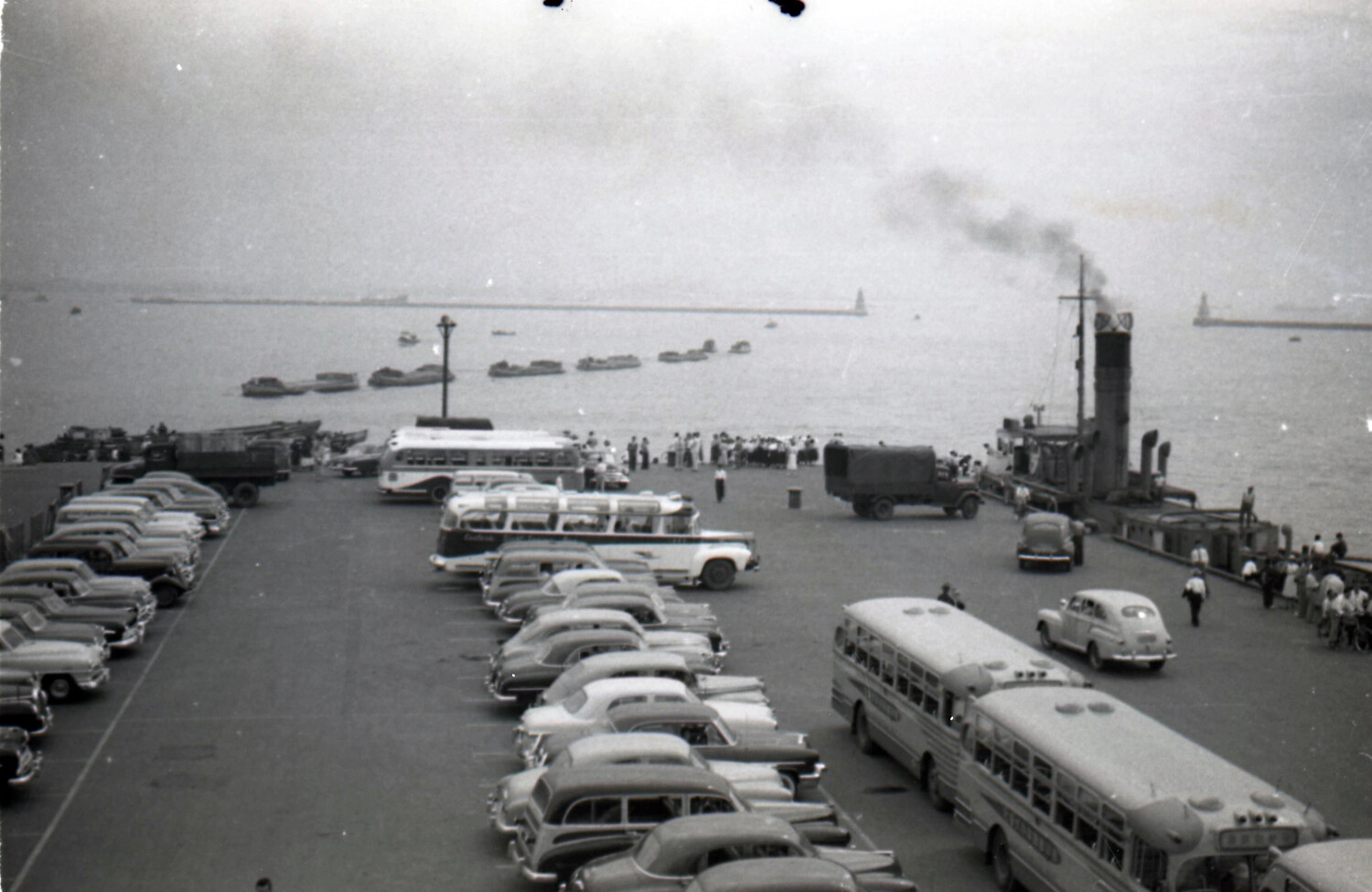 Yokohama Harbor Pier with Parked Automobiles and Buses, Viewed from Shipboard, 1953