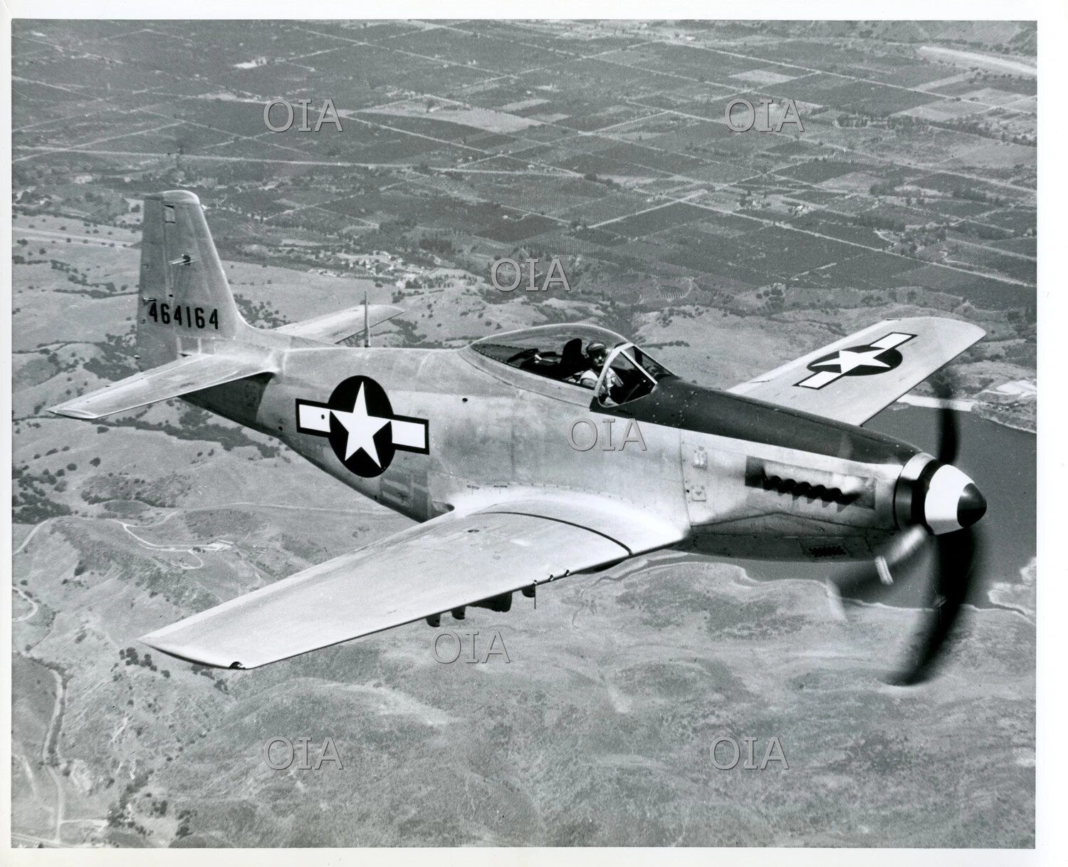 North American P-51 Mustang in Flight Over Farmland, WWII-Era Publicity Photo