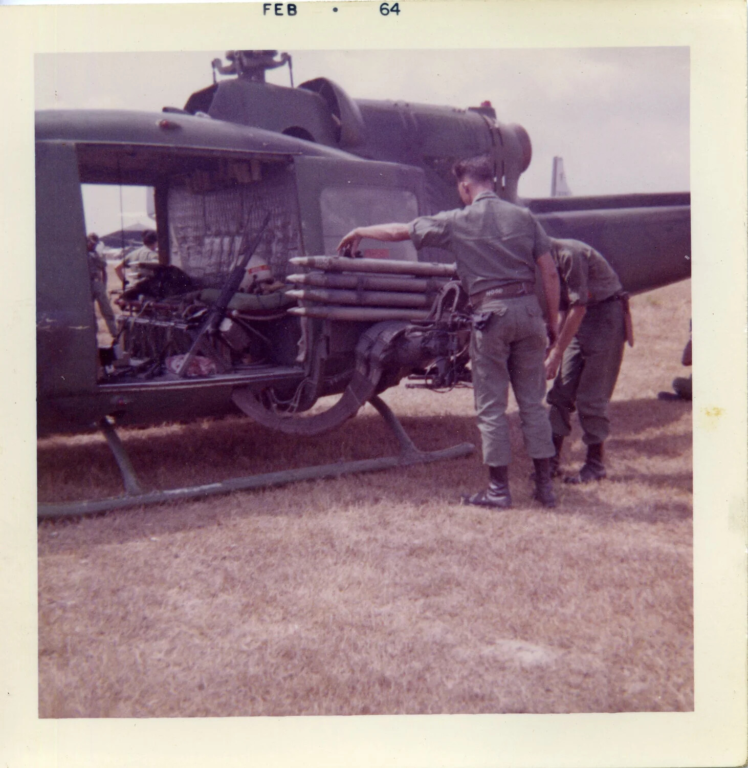 U.S. Army UH-1 'Huey' Helicopter with Aerial Rocket Pod Being Serviced, South Vietnam, February 1964