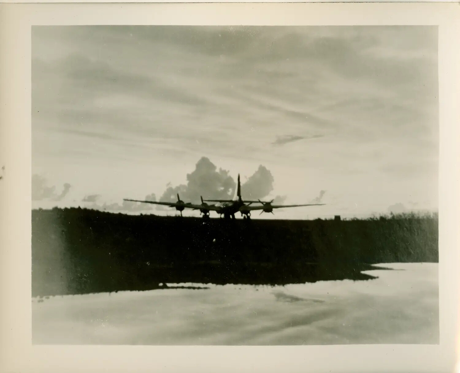 Silhouetted Four-Engine Bomber on Airfield at Dusk, WWII Pacific Theater