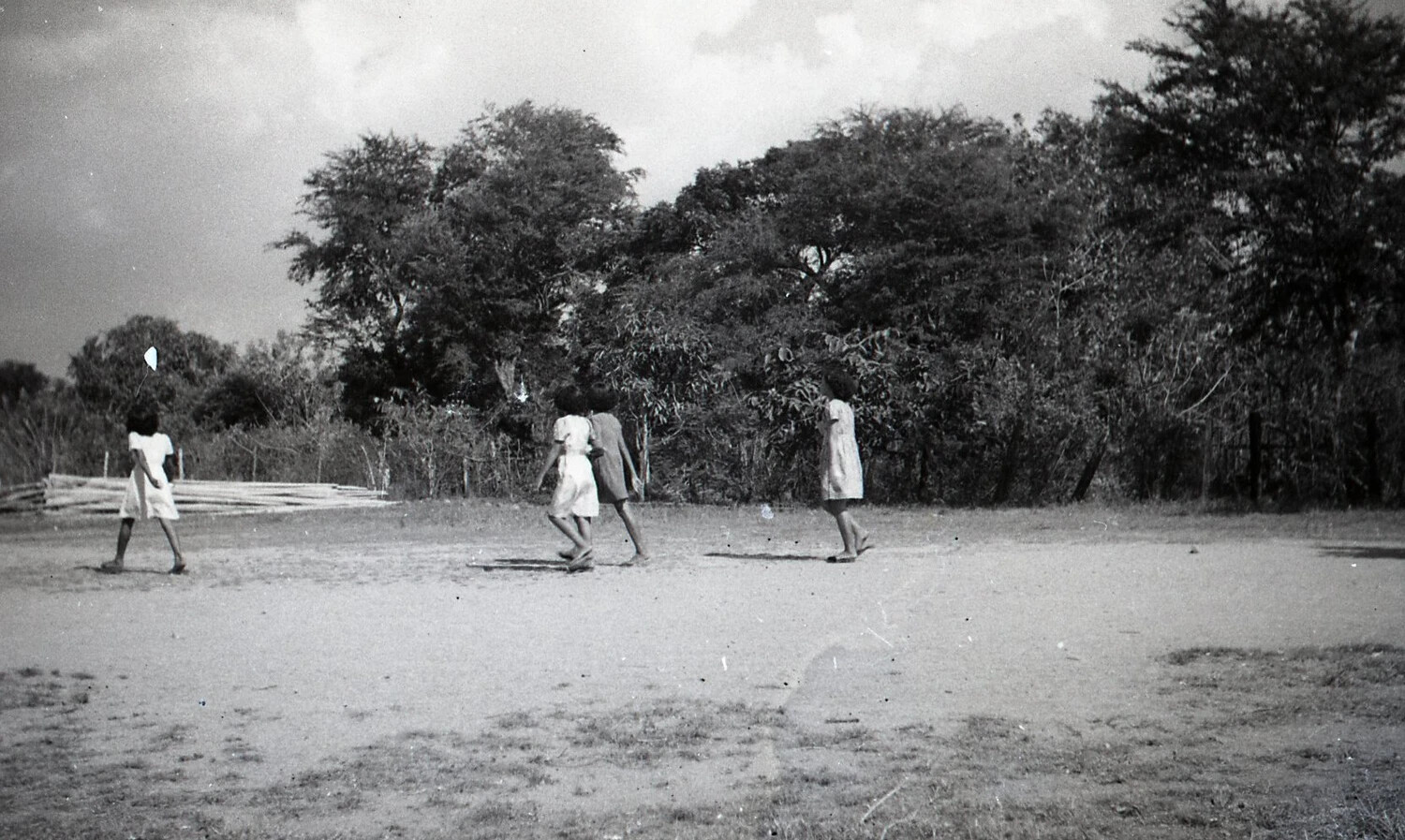 Four Young Girls Walking Across an Open Field, Rural Luzon, Philippines, WWII Era