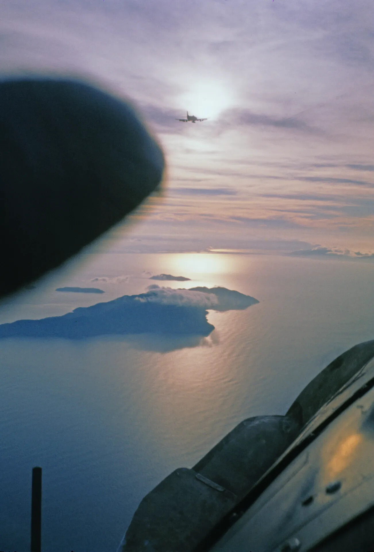 Aircraft Silhouetted at Dusk over Island Coastline, Southeast Asia, Vietnam War Era (Alternate Frame)