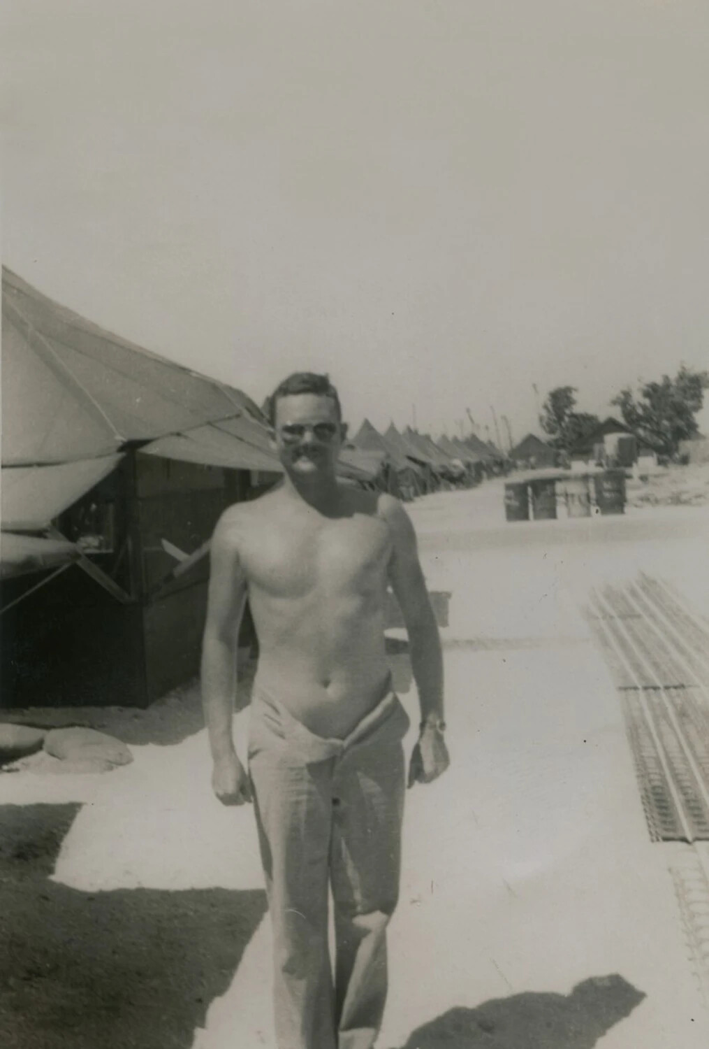 Shirtless Serviceman at Tent Camp with Perforated Steel Planking, McAleer Photo Album