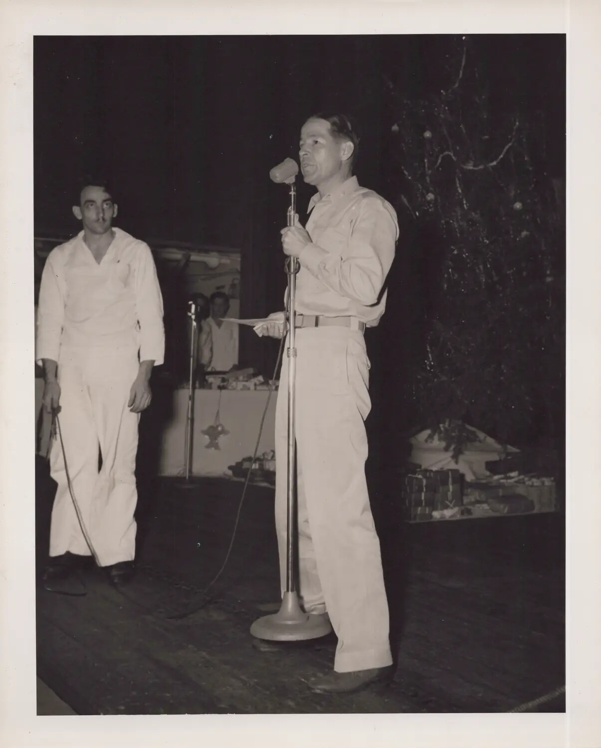 U.S. Navy Sailor Addressing Crew at Shipboard Christmas Program, WWII Era (Ship Identity Unconfirmed)