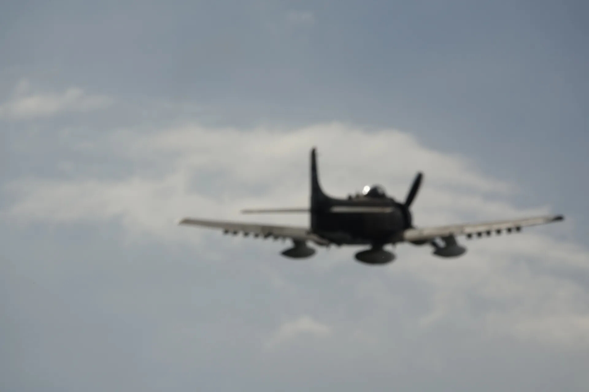 Douglas A-1 Skyraider in Flight, Overcast Sky with Cumulus Cloud, May 2019 Event (Motion Blur)