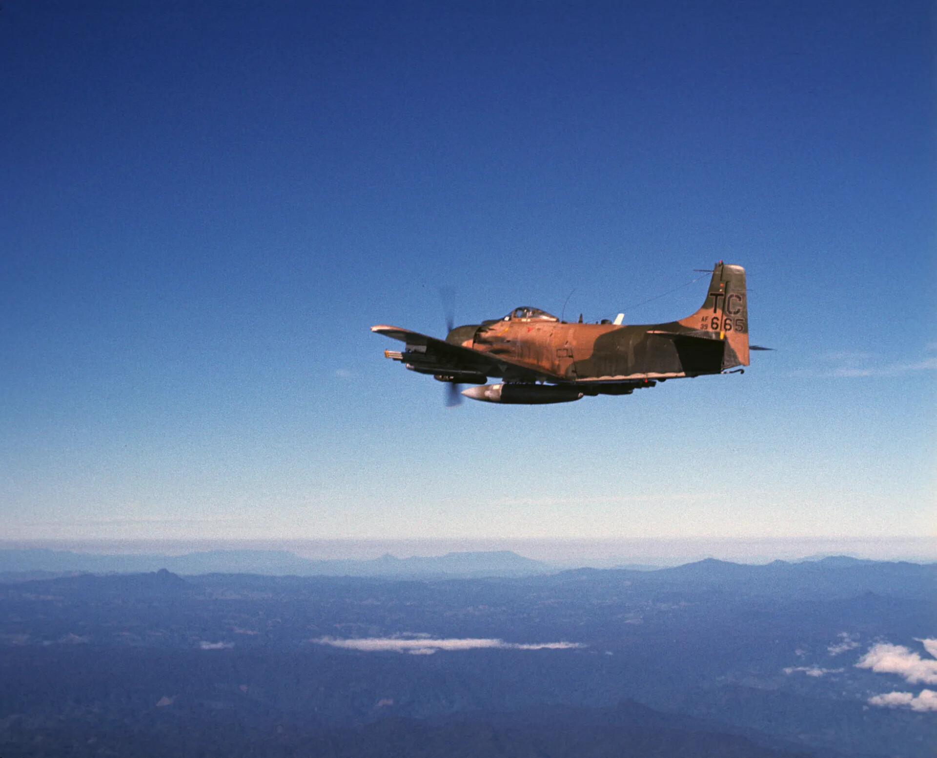A-1 Skyraider 'TC 665' Armed and In-Flight Over Southeast Asian Mountains, Vietnam War Era