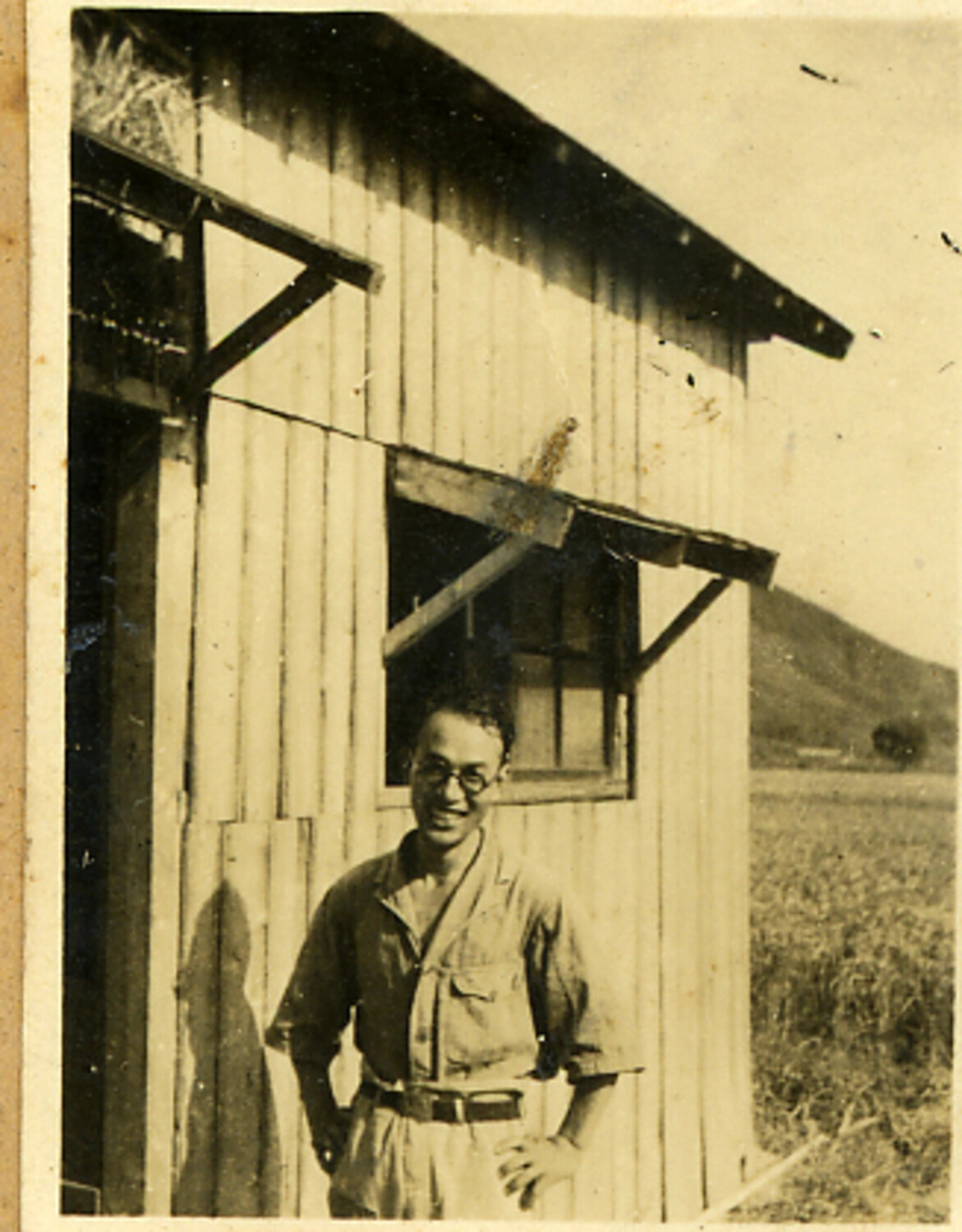 Portrait of a Young Man in Civilian Dress Before a Wooden Farm Building, Rural Japan, WWII Era