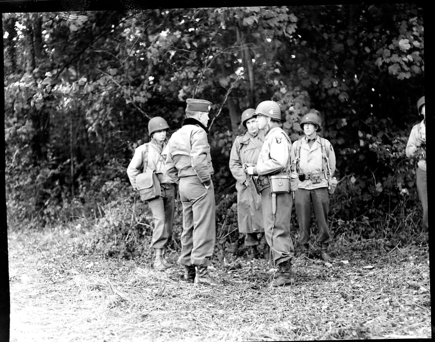 Officer Conferring with 101st Airborne Division Paratroopers in Wooded Terrain, WWII European Theater