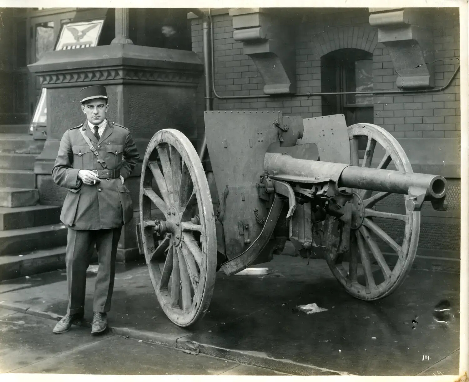 Officer in Kepi Beside Trophy Field Gun at Civic Building Entrance, WWI War Exposition Tour, [Cincinnati, Ohio], 1918