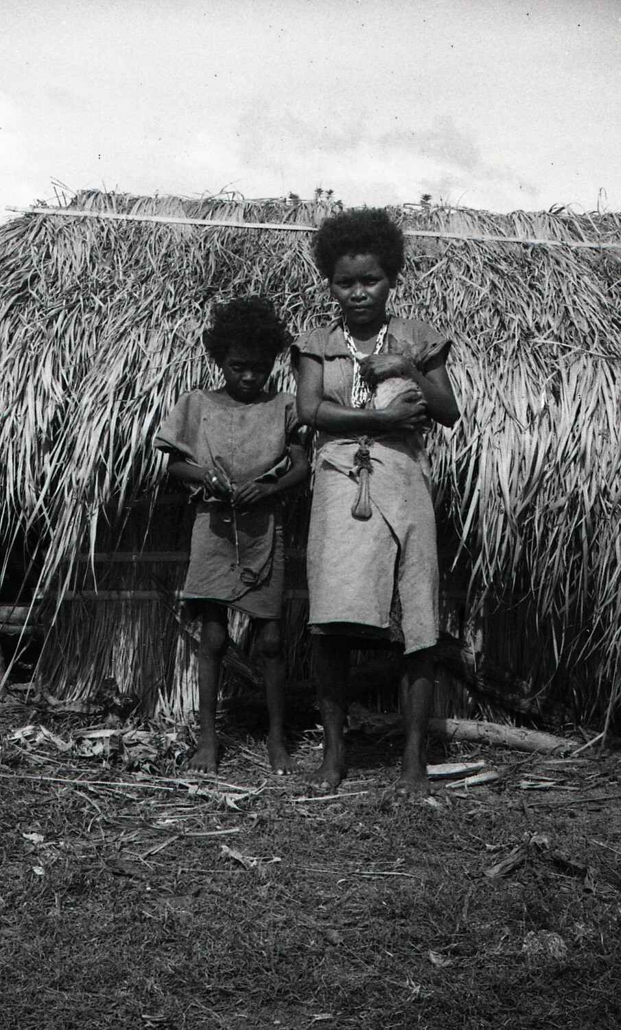 Filipino Woman and Child Outside a Thatched Dwelling, Luzon, Philippines, WWII Era