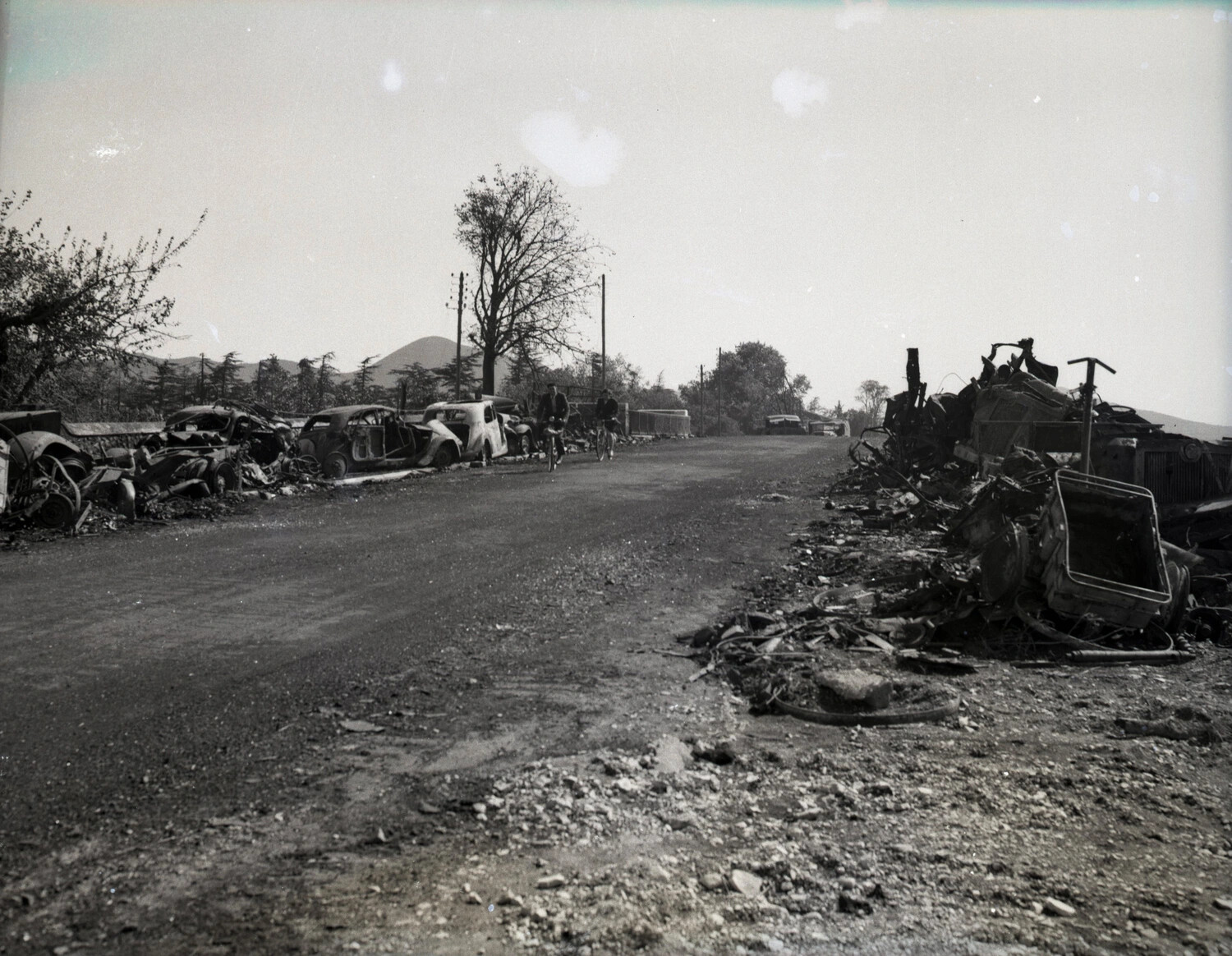 Roadside Vehicle Wreckage and Cyclists, World War II Germany