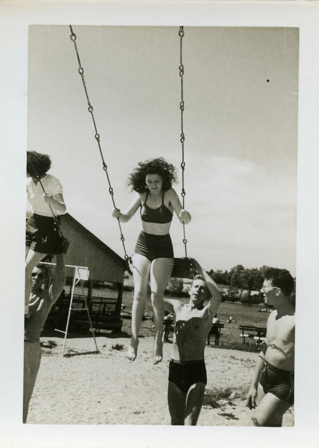 Servicemen and Companions at Lakeside Swing Set During Recreational Outing, WWII Era