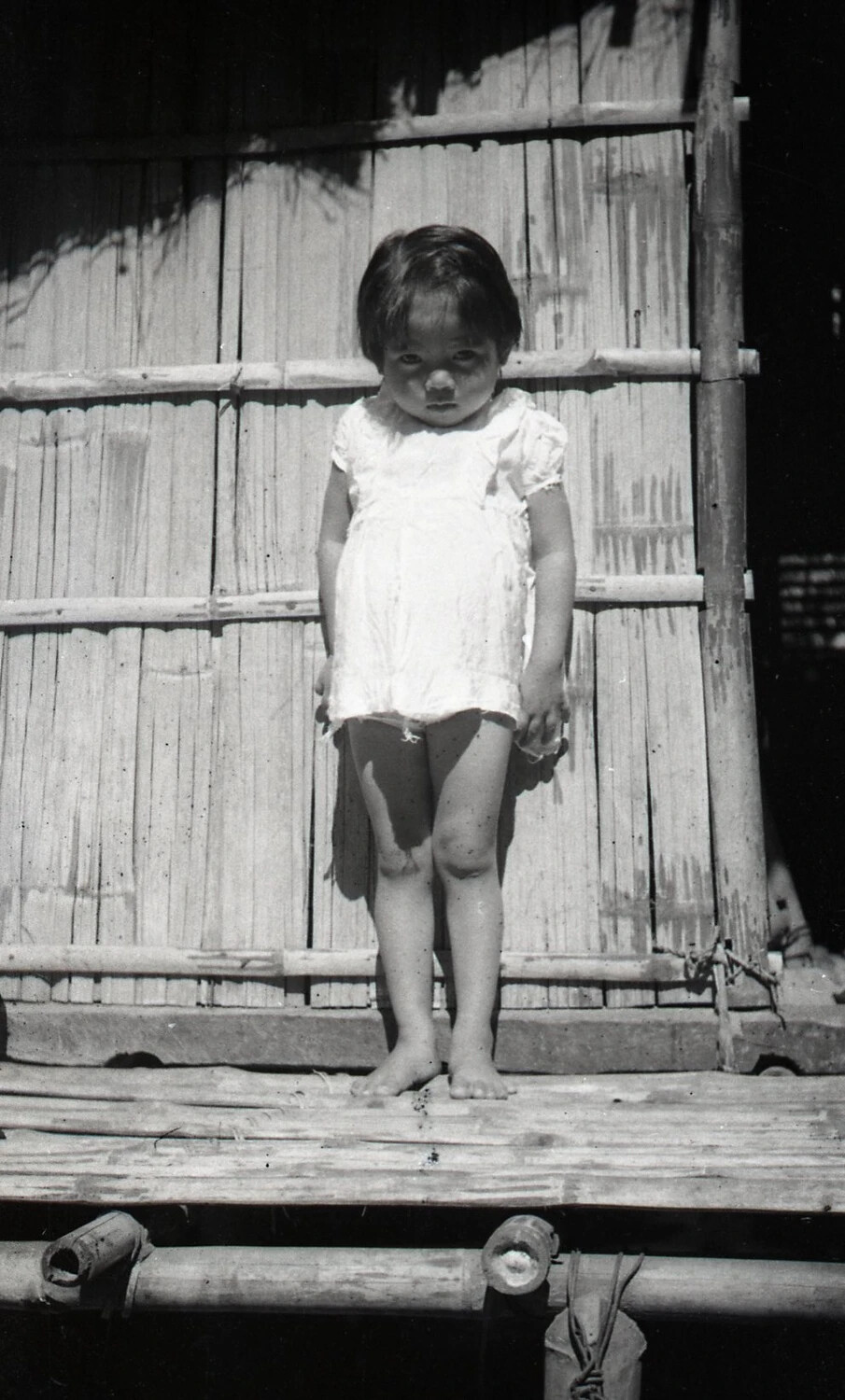 Filipino Child on Bamboo Porch, Luzon, Philippines, WWII Era
