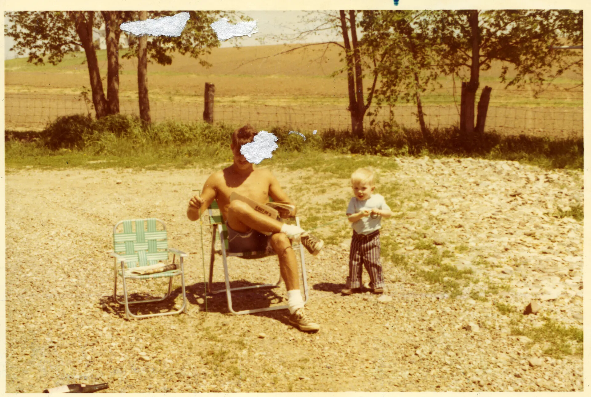 Man and Child in a Farmyard, Family Snapshot (Damaged Print)