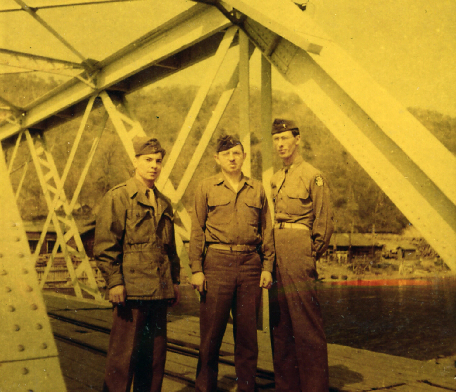 Three Servicemen Posed Beneath a Steel Truss Bridge, Japan, circa 1950s