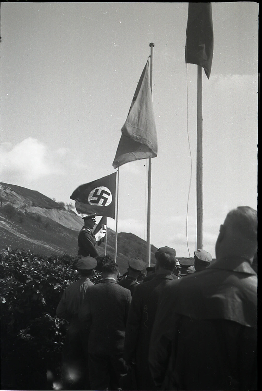 German Officer Beside Swastika Flag at Outdoor Assembly, WWII Era (Companion Frame)