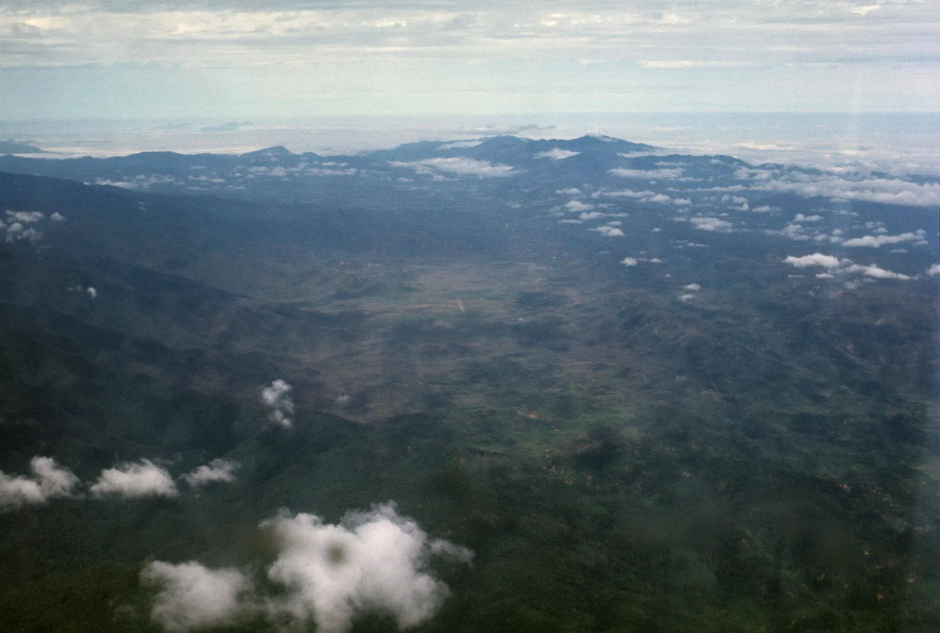 Aerial Landscape View of Forested Mountains and Cloud Cover