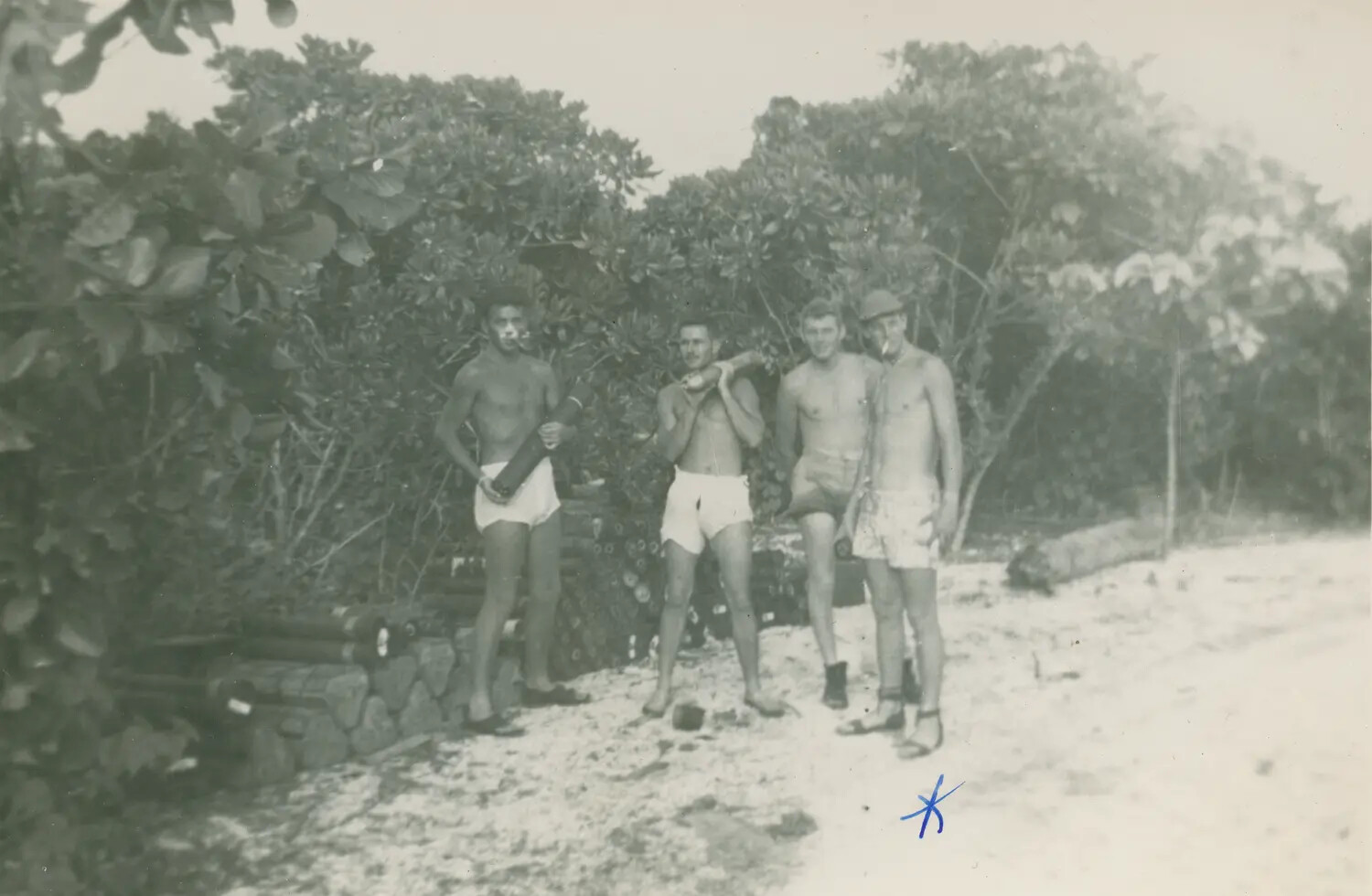 Four Servicemen on Tropical Beach Near Stacked Ordnance, McAleer WWII Photo Album