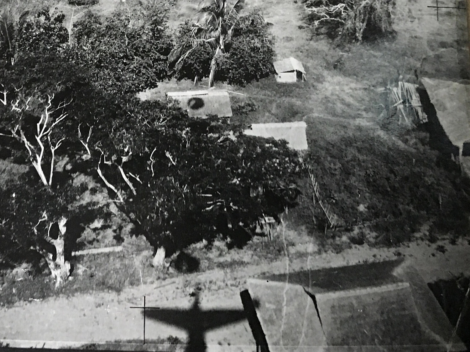 Low-Altitude Strike Photograph with Aircraft Shadow over Philippine Village Target, 312th Bomb Group