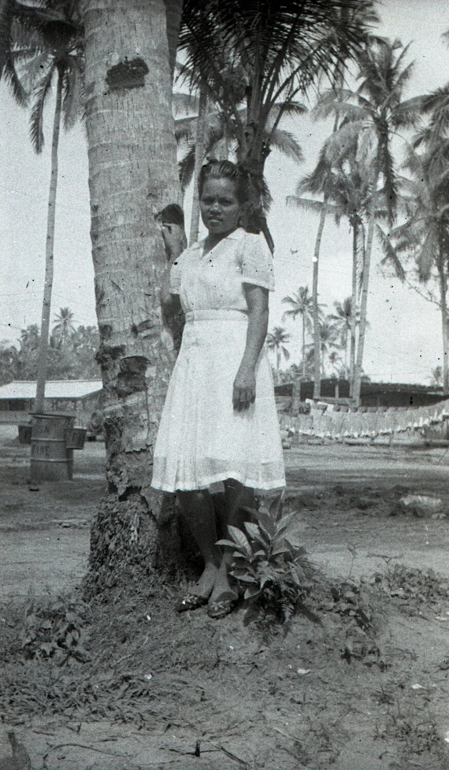 Young Woman Beside Palm Tree Near Military Camp, Luzon, Philippines, WWII Era