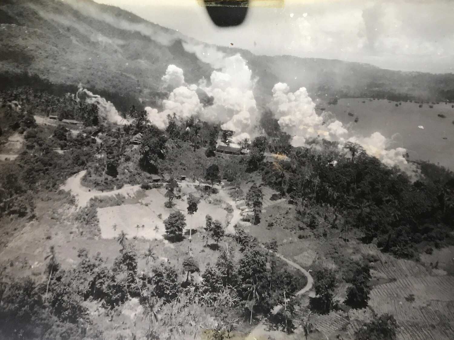 Aerial View of Bombing Raid on Coastal Base with Anchored Vessels, New Guinea