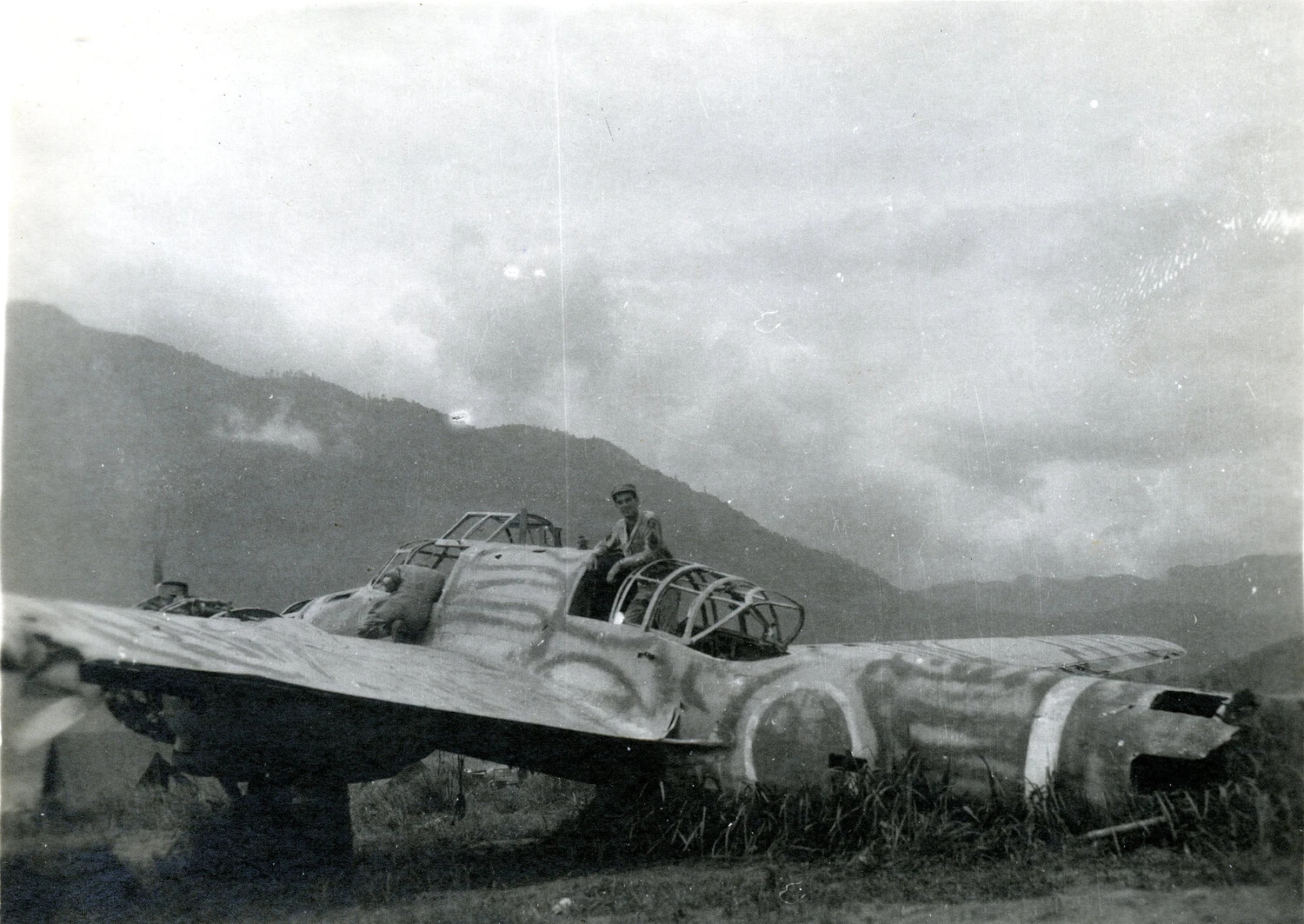 American Serviceman Posed on Wrecked Twin-Engine Aircraft Fuselage, Pacific Theater, WWII (Ie Shima/345th Bomber Group Collection)
