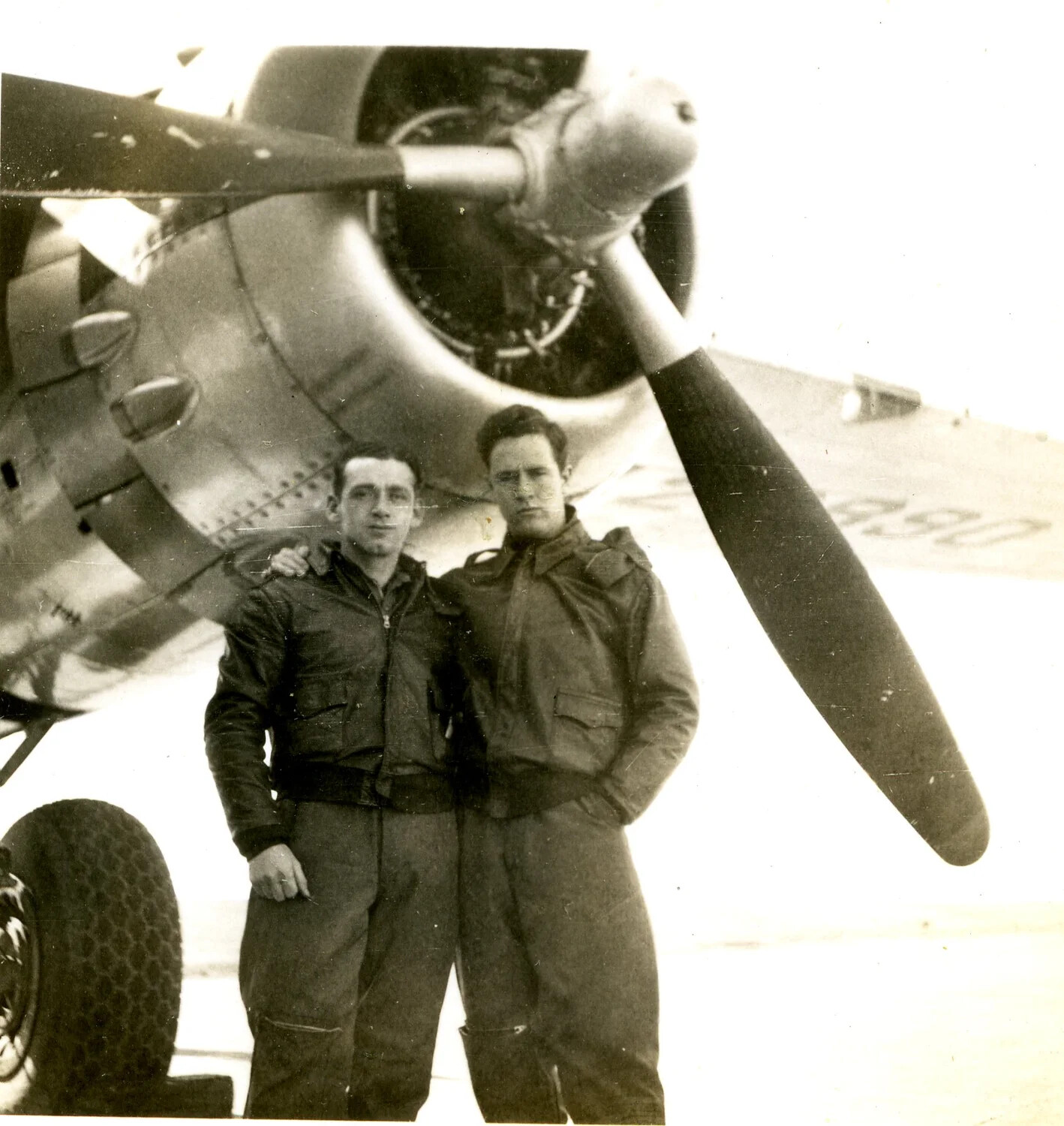 Two Airmen Beneath Radial Engine and Propeller of Military Aircraft, WWII-era Photograph