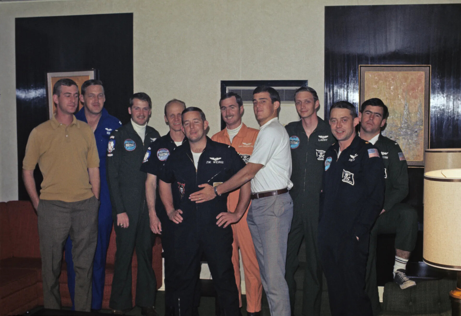 Group Portrait of Flight-Suited Aviators with Squadron 'Pirate' Patches, Officers' Club Setting