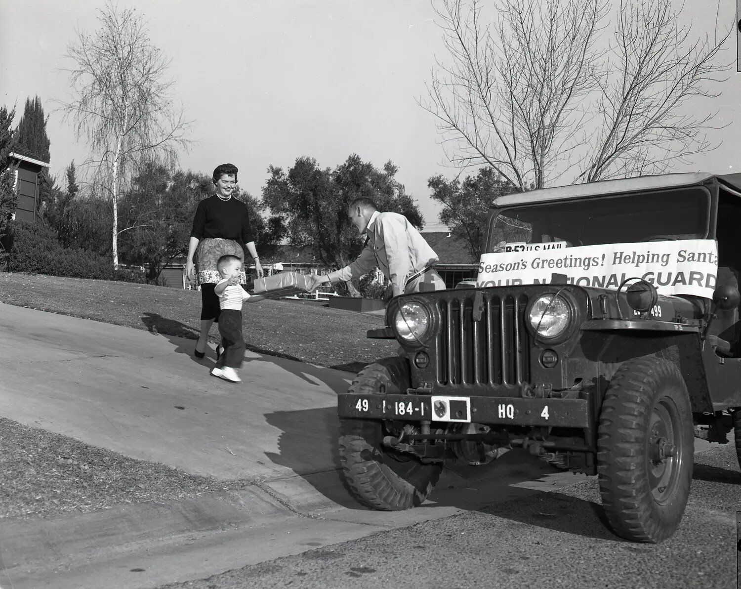 National Guard M38A1 Jeep Christmas Toy Delivery, Suburban Residence, c. late 1950s (Frame 5)