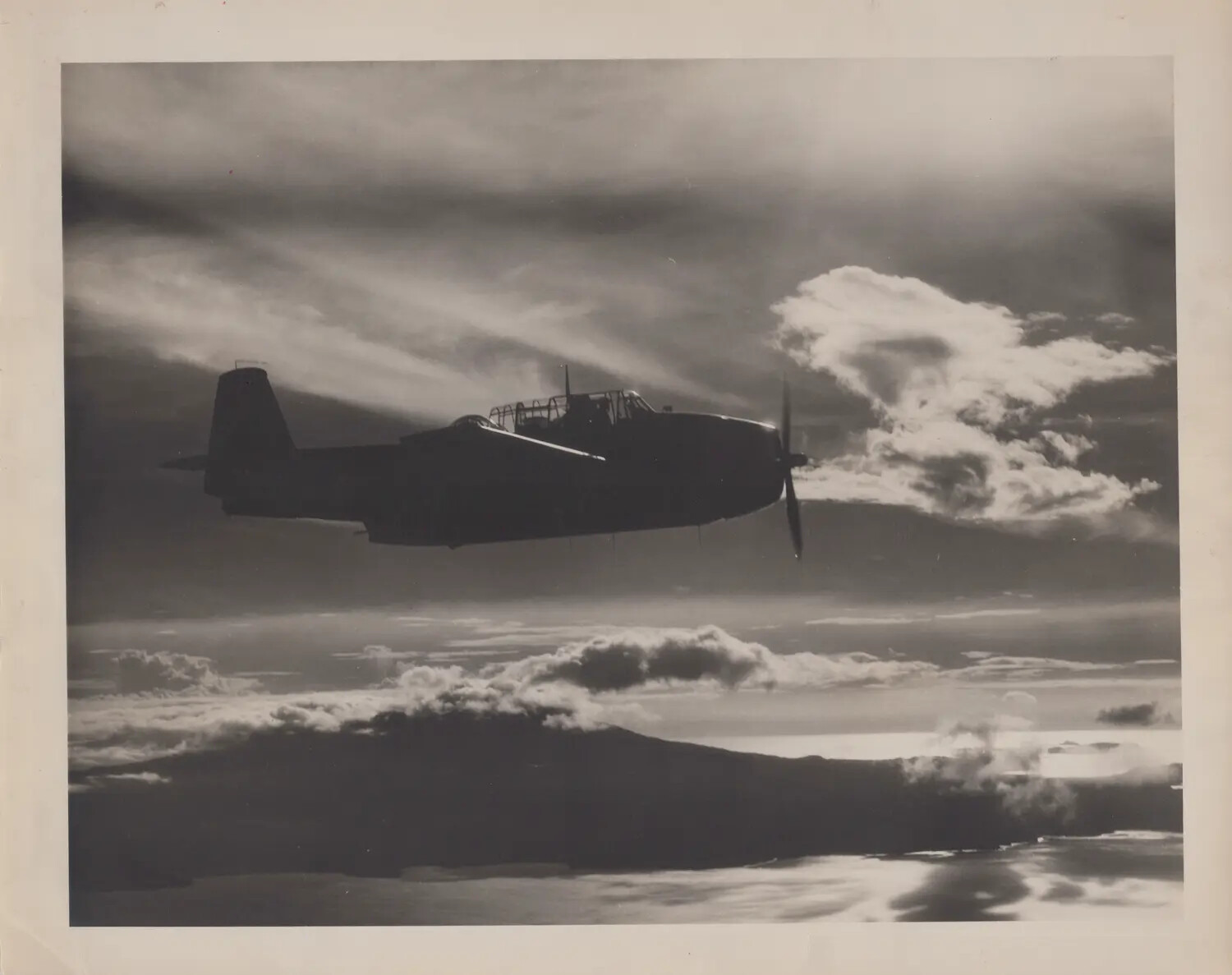 TBM/TBF Avenger Torpedo Bomber in Flight, Silhouette Against Clouds, WWII