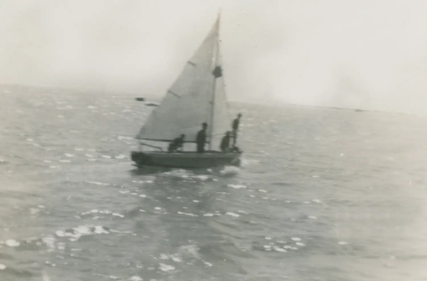 Sailboat with Crew Underway, Close View, Sun Glare on Water