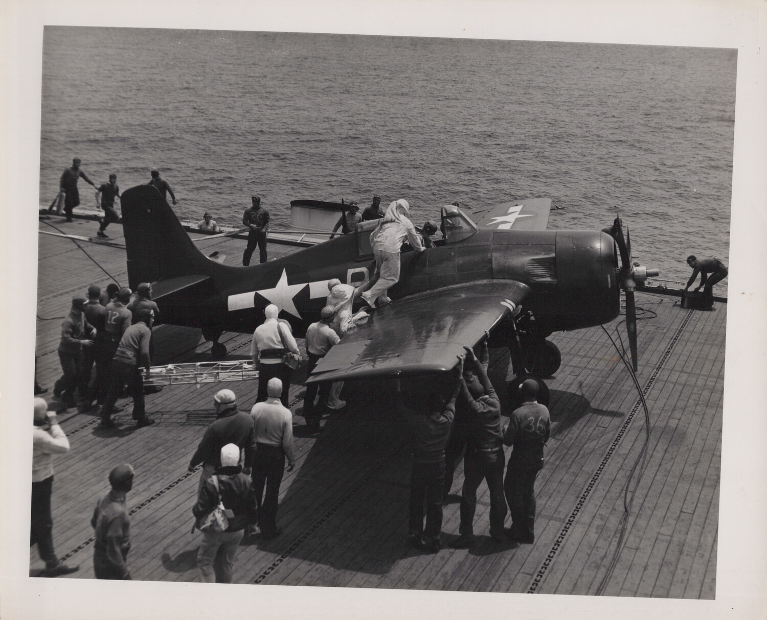 Deck Crew Spotting a Fighter Aircraft Aboard USS Petrof Bay (CVE-80), WWII