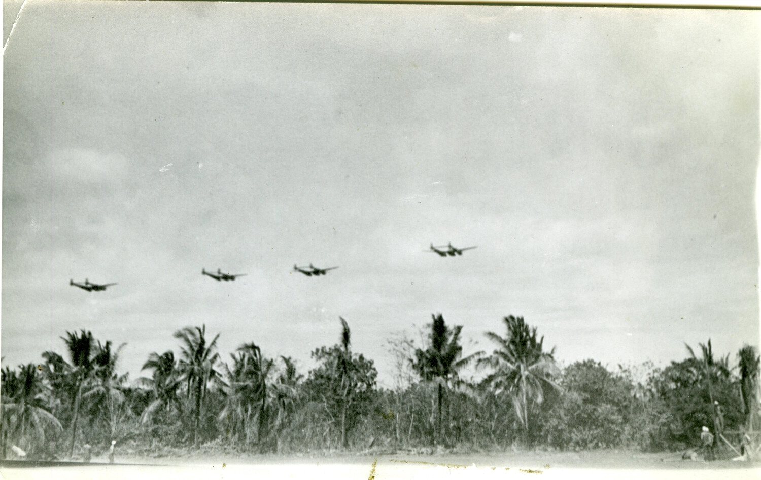 Formation of P-38 Lightning Fighters Over a Pacific Island Airstrip, April 1945