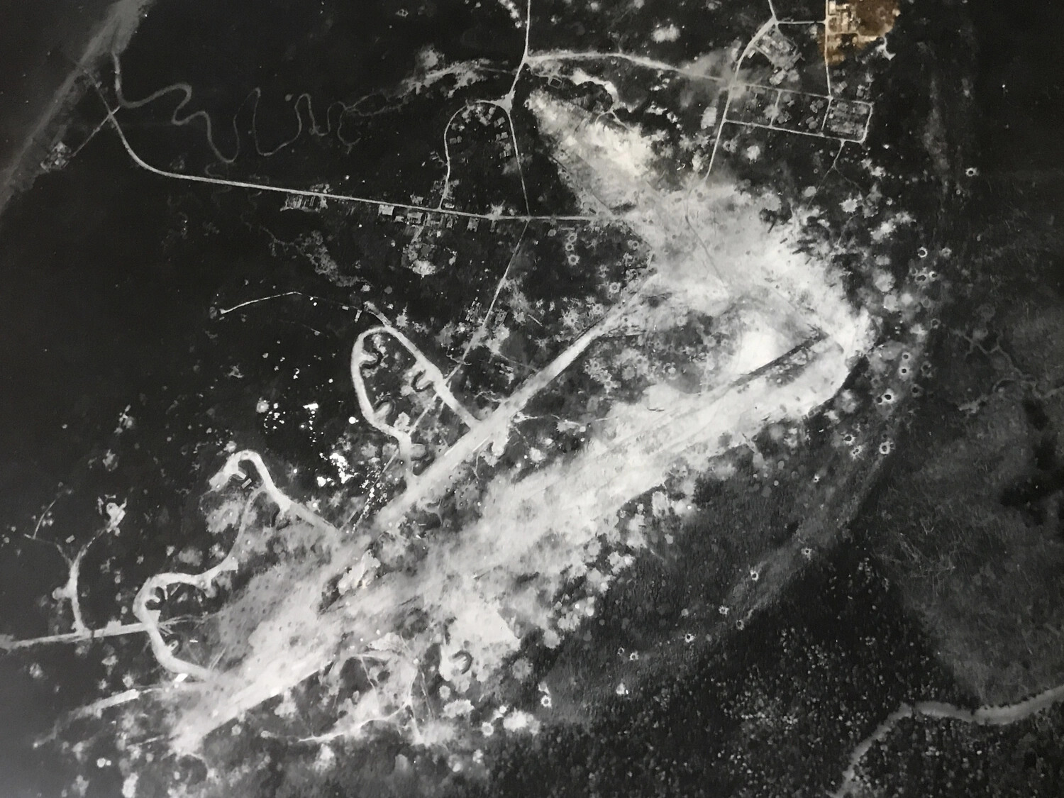 Vertical Aerial Reconnaissance Photograph of Bomb-Damaged Japanese Airfield Runway