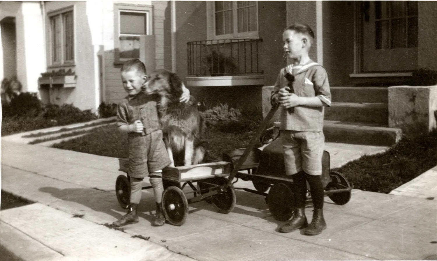 Two Boys with Homemade Wagons and Family Dog on Residential Sidewalk, c. 1920s-1930s (Non-Military Item, Appears Misfiled in CBI Archive)