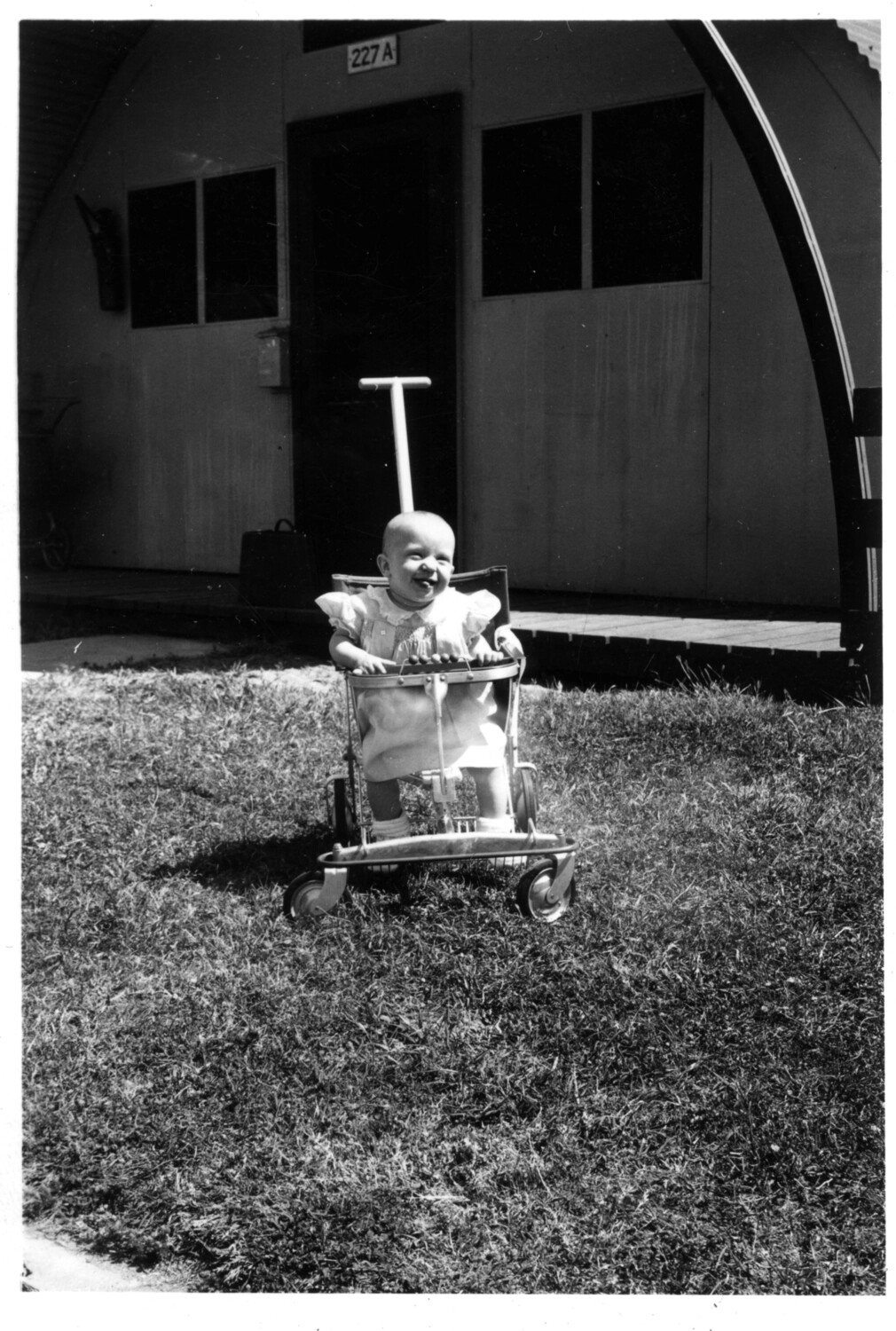 Infant in Baby Walker Outside Quonset Hut No. 227-A, Lt. Bancroft Family Collection, Korean War Era