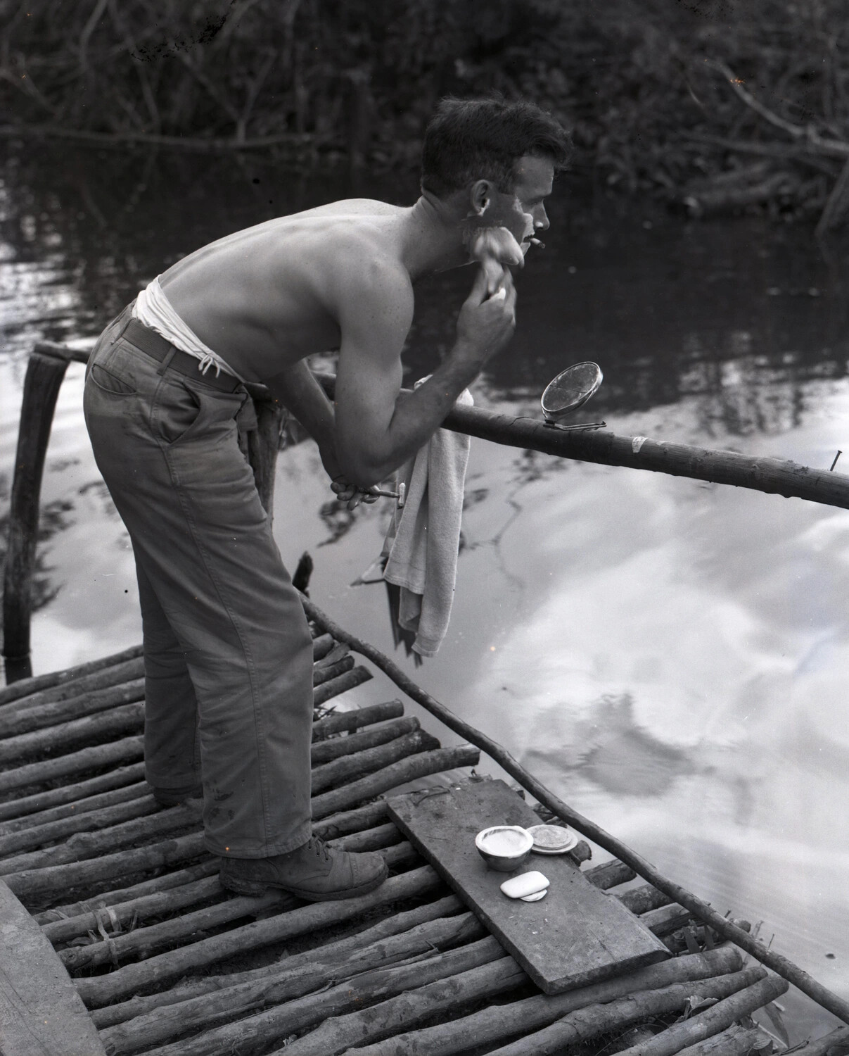 Serviceman Shaving on Bamboo River Dock, Myitkyina, Burma, WWII