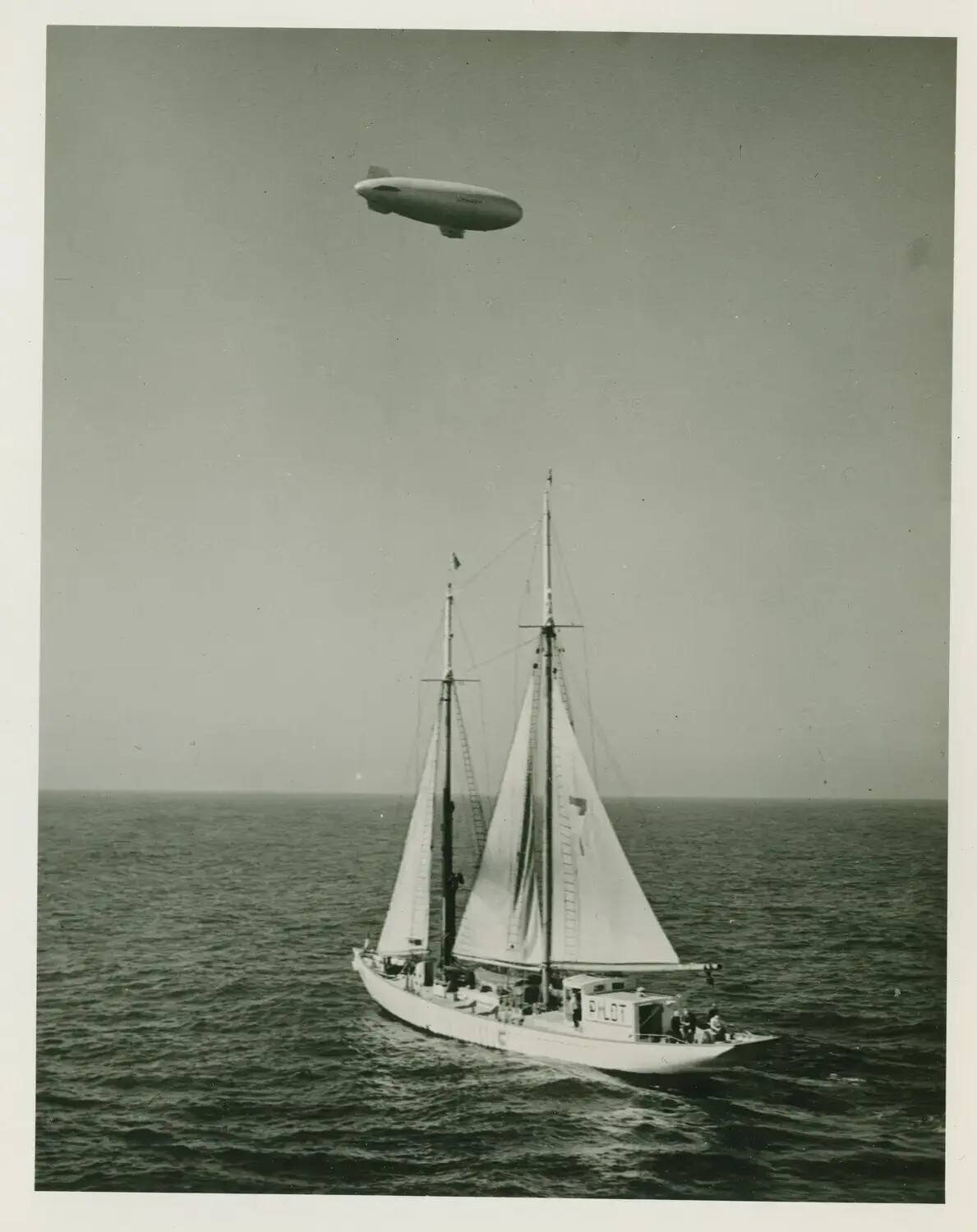 Sailing Pilot Boat and Airship (Blimp) at Sea