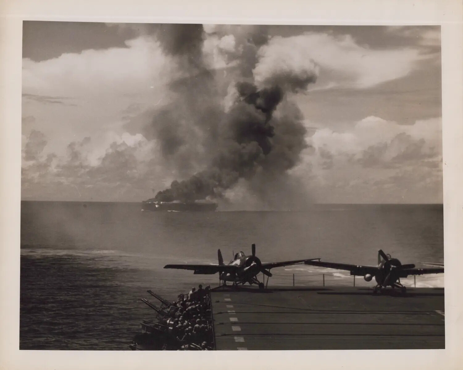 Escort Carrier Burning on the Horizon, Viewed from Sister Ship's Flight Deck, WWII Pacific Theater