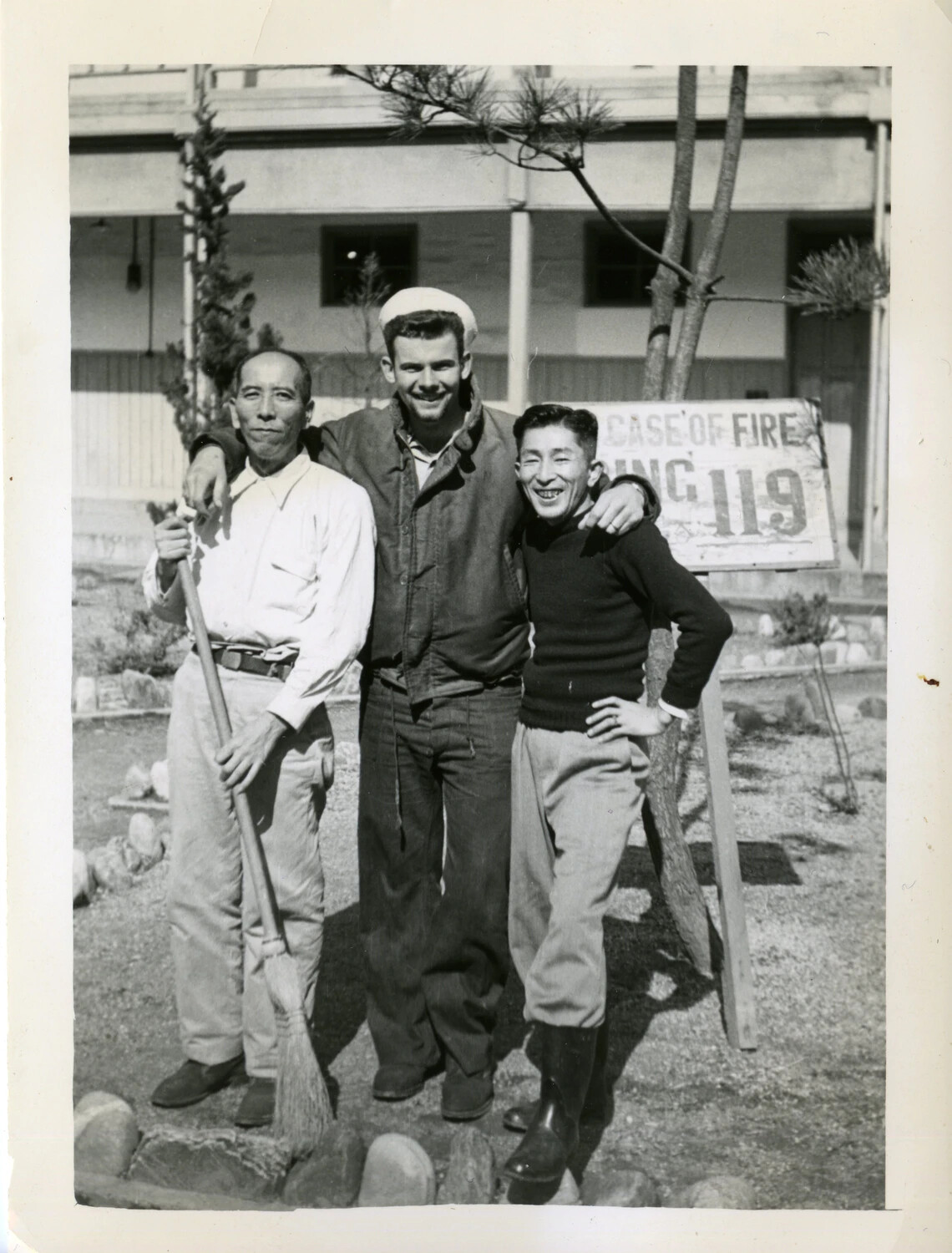 US Navy Sailor with Local Civilian Workers at Base, Joseph Smith Material - Lt. Bancroft Korean War Collection