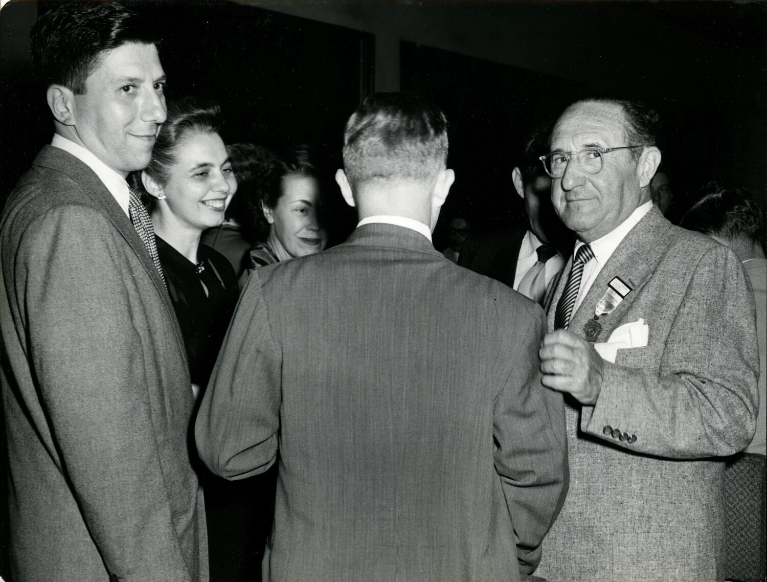 Convention Attendees Mingling at Reception, Featuring Recurring Honoree Figure, Late 1940s