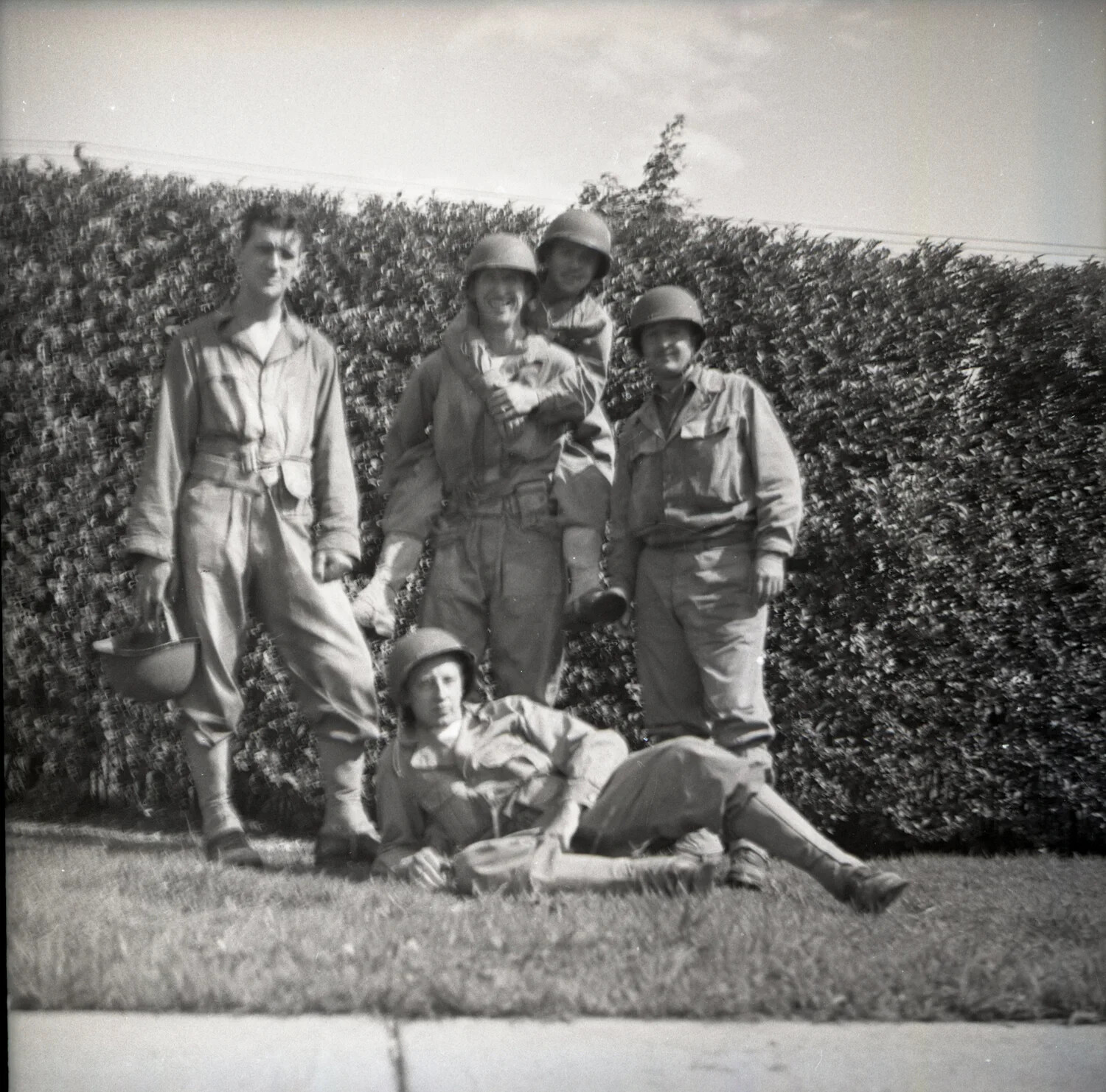 Five Servicemen in Fatigues and Steel Helmets Posed Before a Hedge